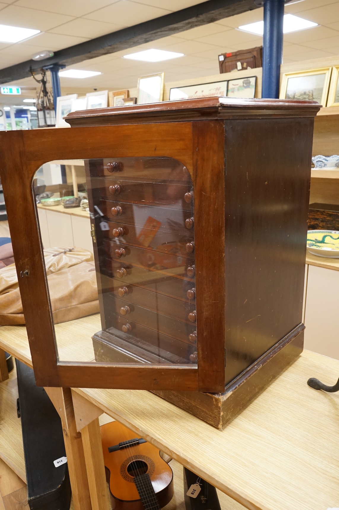 A Victorian ten drawer mahogany collector’s cabinet, containing a large selection of taxidermy moths, the contents checked against the UK register, each drawer with glazed cover, with a lockable glazed main door and orig